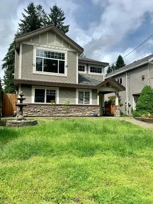 a house with a green lawn in front of it at 3 Bedrooms 1 Bath in SHARE HOUSE at Coquitlam Central Mall & skytrain in Port Coquitlam