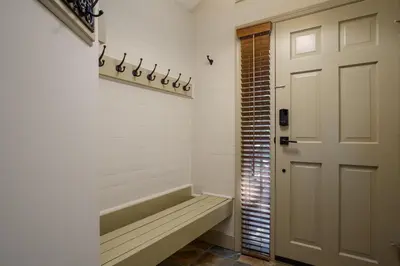 a bathroom with a bench next to a door at 2BR in Blackcomb Greens, Wood Fireplace, Hot Tub Access, Mountain Views, Free Ski Shuttle, Parking in Whistler