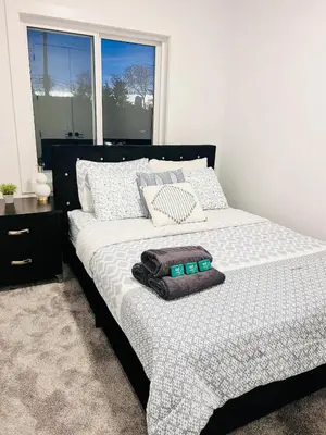 a bedroom with a bed with two towels on it at M21 Luxurious, Downtown River Valley Home, Centrally located, Close to everything in Edmonton