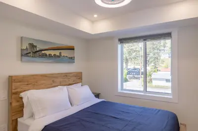 a bedroom with a bed and a window at Premium Deluxe suites 201 in Peachland