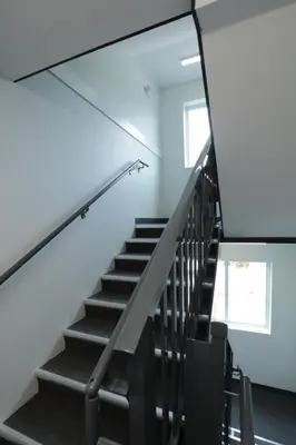 a staircase in a room with white walls and a stair case at Premium Deluxe suites 201 in Peachland