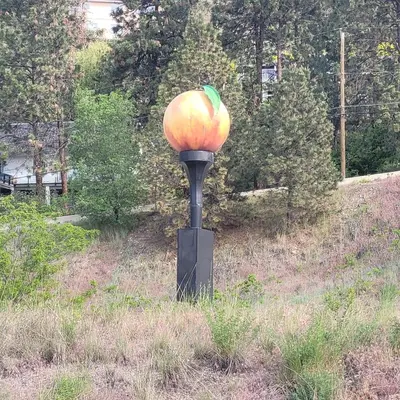 a statue of a pumpkin on a pole in a field at Premium Deluxe suites 201 in Peachland