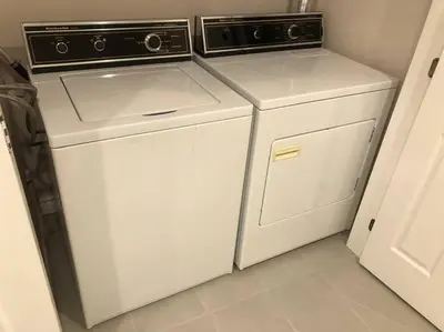 a laundry room with a washer and dryer at heated pool, hot tub, 3 AC ensuites, lake view in West Kelowna