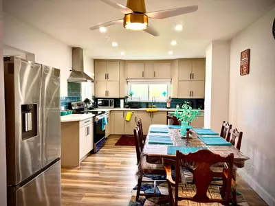 a kitchen with a table and a refrigerator at DreamLand Farms, Edmonton in Duffield