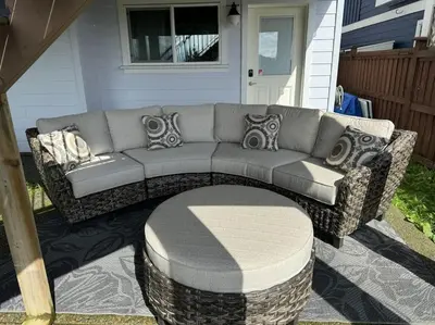a gray couch sitting on a patio with an ottoman at Super wow view! in Victoria