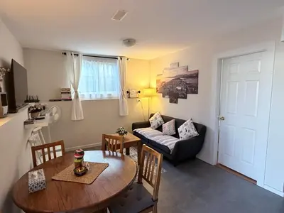a living room with a table and a couch at 2BR 1BA Garden View Guest Suite - King-size Bed - Free Parking in Vancouver