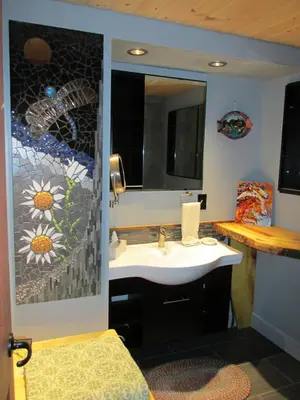 a bathroom with a sink and a mirror at beard's creek bed and breakfast in Parson