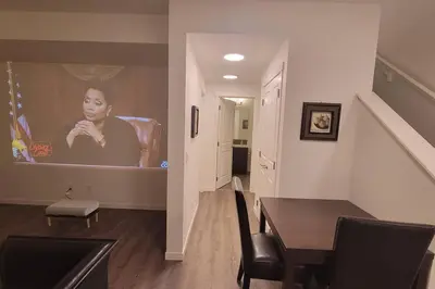 a dining room with a picture of a woman on a wall at Brand New Suite in the Lakes in Calgary