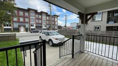 a car parked on a porch of a house at King and Queen rooms -J&J Chilliwack in Chilliwack