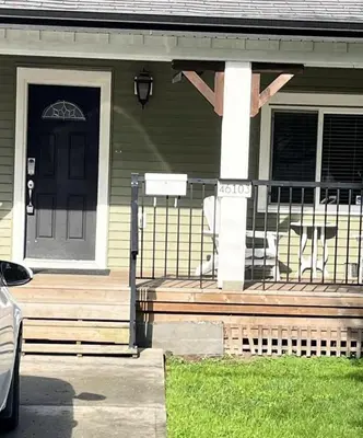a house with a front porch with a black door at King and Queen rooms -J&J Chilliwack in Chilliwack
