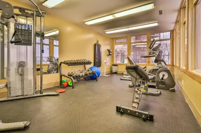 a gym with treadmills and exercise equipment in a room at Lake Windermere Pointe by StayIn in Invermere