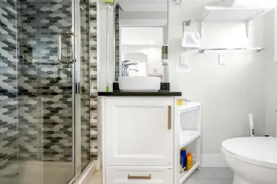 a bathroom with a sink and a shower at New laneway house near Airport, World Cup stadium, Downtown, UBC in Vancouver