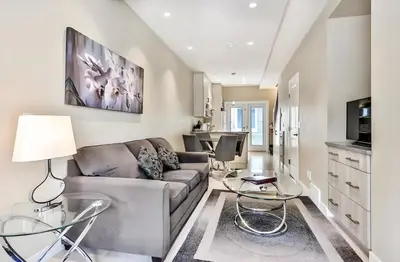 a living room with a couch and glass tables at Mountain Surrounded Lodge in Harvie Height in Canmore