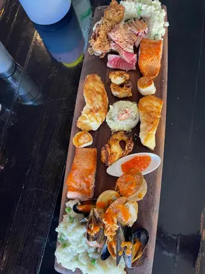a tray of different types of food on a table at Bratty Catty Cabin in Powell River