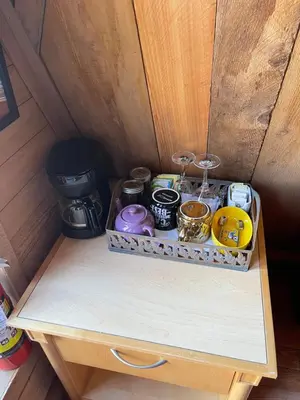 a tray of items on a wooden table in a room at Bratty Catty Cabin in Powell River