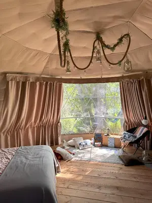 a bedroom with a bed and a tent at D3 Rainforest Getaway Dome- 2Dbl beds in Drumheller