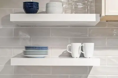 two cups and plates on a shelf in a kitchen at KING Bed - Premium STUDIO Suite - Ski Valet - Village in Whistler