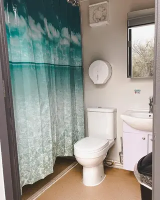 a bathroom with a toilet and a sink at D5 Nordic Nook - 1 King Suite in Drumheller