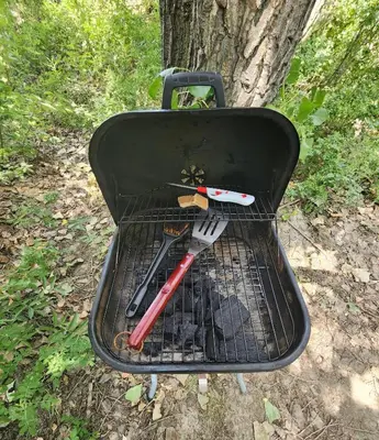 a grill with utensils sitting on top of it at D5 Nordic Nook - 1 King Suite in Drumheller