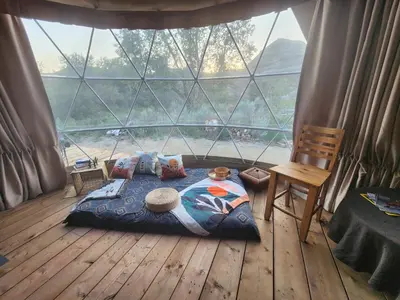 a bedroom with a bed in front of a large window at D6 Sahara Sunset- King Suite Very Private in Drumheller