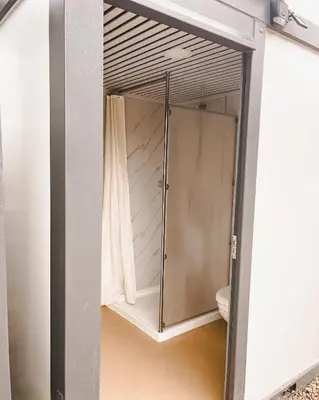 a glass door leading into a bathroom with a shower at D6 Sahara Sunset- King Suite Very Private in Drumheller
