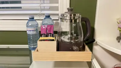 a coffee maker and two bottles of water in a drawer at Warm home in Richmond