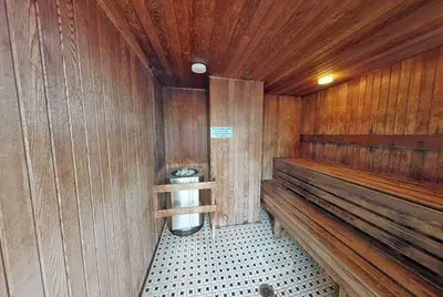 a sauna with a toilet in a wooden wall at Stylish 2BD Condo in Downtown with Marina View in Vancouver