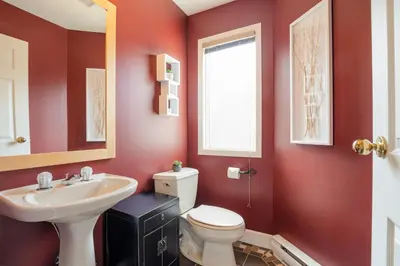 a bathroom with a white toilet and a sink at 4BR in Blueberry Hill Estates, Mountain Views, Large Family Home, Wood Fireplace, Balcony in Whistler