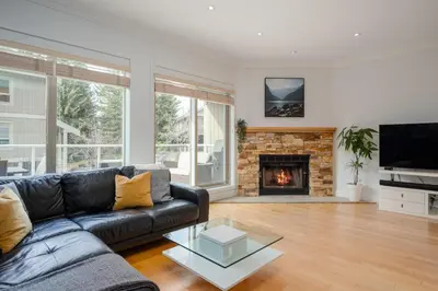 a living room with a couch and a fireplace at 4BR in Blueberry Hill Estates, Mountain Views, Large Family Home, Wood Fireplace, Balcony in Whistler
