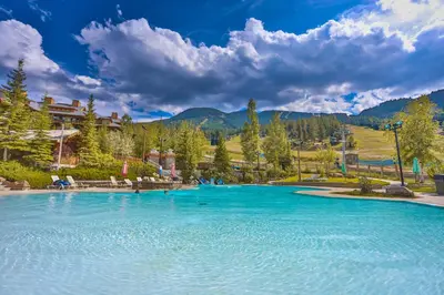a large pool of blue water in a resort at Nordix Townhomes by StayIn in Panorama