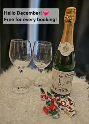 a bottle of champagne and two wine glasses on a table at Lovely Cozy Room! with Attached Private Bath in the Heart of Vancouver! Private Parking & Self Check-in! in Vancouver