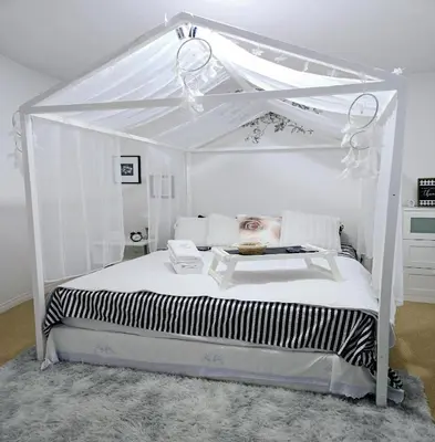 a white bed with a canopy in a bedroom at Lovely Cozy Room! with Attached Private Bath in the Heart of Vancouver! Private Parking & Self Check-in! in Vancouver