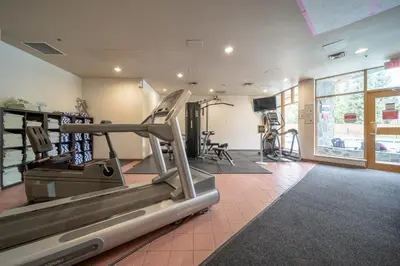 a gym with a treadmill and exercise equipment at Mid Century Modern - Studio w Pool & Hot Tub in Whistler