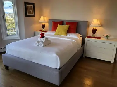 a bedroom with a bed with two stuffed animals on it at Heated pool, hot tub, 4 AC lake view bedrooms in West Kelowna
