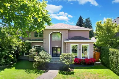 a house with a yard with a fence at Beautiful Dunbar Home in Vancouver
