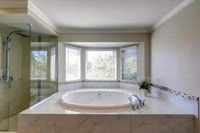 a large bathroom with a tub and a shower at Beautiful Dunbar Home in Vancouver