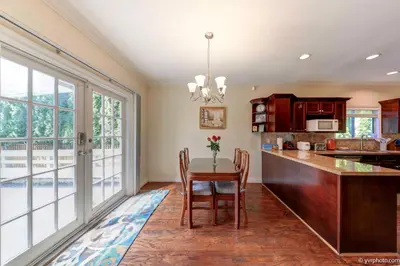 a kitchen with a table and chairs and a large window at Beautiful Dunbar Home in Vancouver