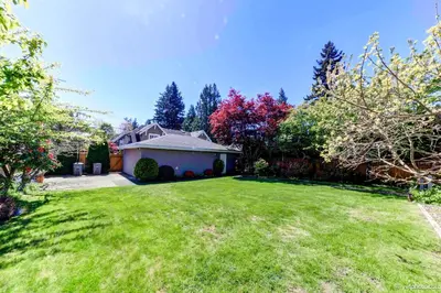 a house with a yard with green grass at Beautiful Dunbar Home in Vancouver