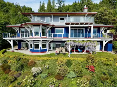 an aerial view of a large blue house at Blue House in Gibsons