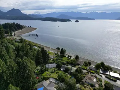 an aerial view of a beach next to the water at Blue House in Gibsons