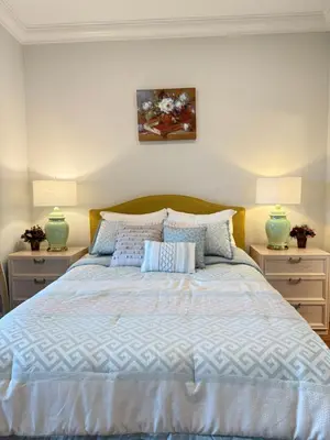 a bedroom with a large bed with two night stands at Blue House in Gibsons