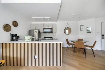 a kitchen and dining room with a table and chairs at a fully renovated condo near village centre with MT view and close to lift in Cascade lodge in Whistler