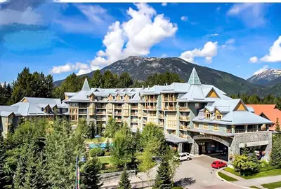 an image of a resort with mountains in the background at a fully renovated condo near village centre with MT view and close to lift in Cascade lodge in Whistler