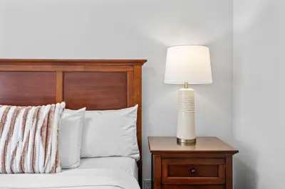 a bedroom with a bed with a lamp on a nightstand at B111 Hot tub, ACx3, parking, coin laundry, near Banff in Canmore