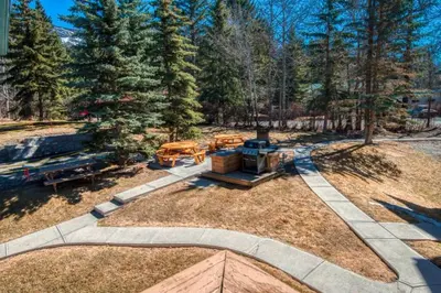 an aerial view of a yard with trees at B111 Hot tub, ACx3, parking, coin laundry, near Banff in Canmore