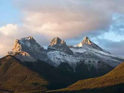 a mountain with snow on top of it at B111 Hot tub, ACx3, parking, coin laundry, near Banff in Canmore