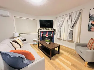 a living room with a couch and a table at B111 Hot tub, ACx3, parking, coin laundry, near Banff in Canmore