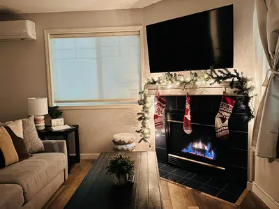 a living room with a fireplace with christmas decorations at B111 Hot tub, ACx3, parking, coin laundry, near Banff in Canmore