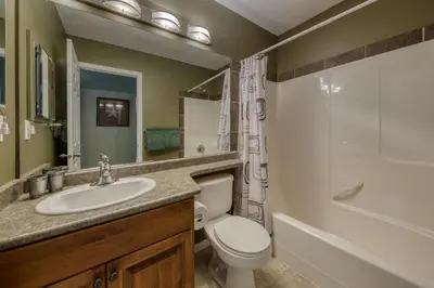 a bathroom with a sink and a toilet and a shower at The Peaks 3 Bedroom Mountain View Condo in Radium Hot Springs