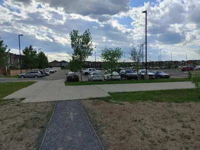 a parking lot with a bunch of cars parked at Genesis Townhouse in Calgary